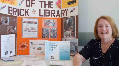Sue MacDougall hosts the membership table for National Friends of Libraries Week